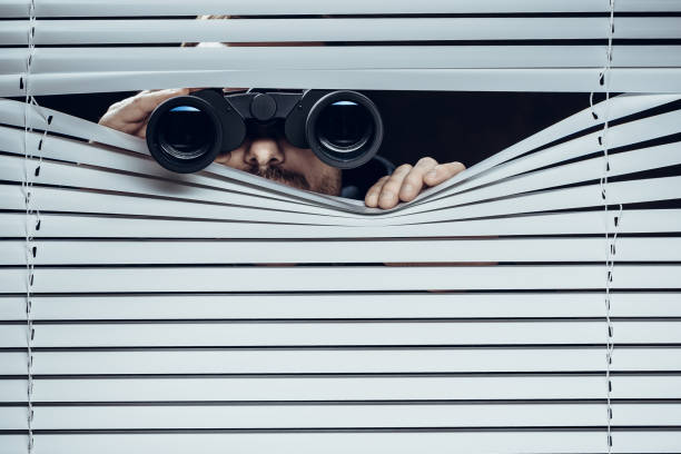 Spy at work. Man with binoculars. Sarasota Private Investigator